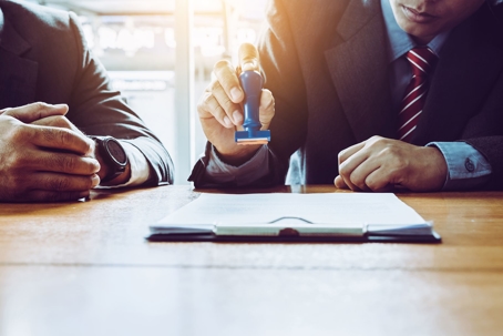 Lawyers with document to sign